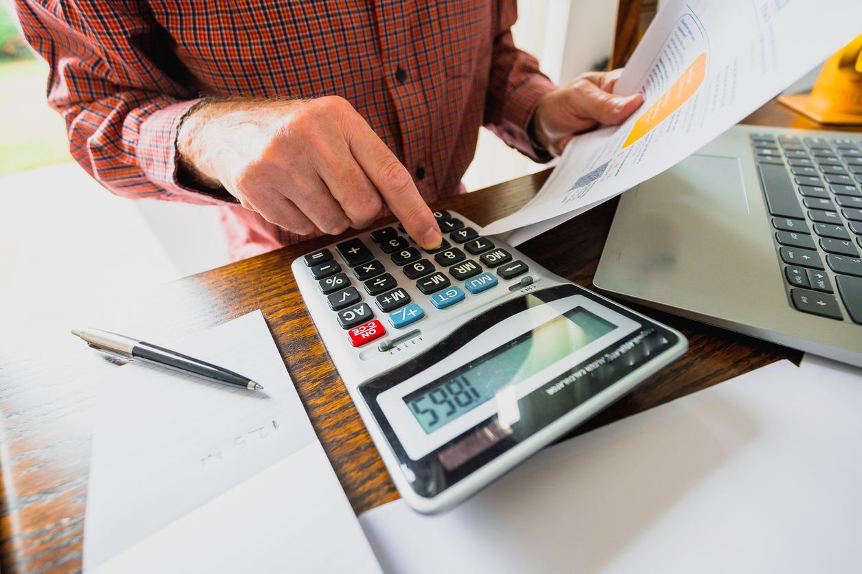 Senior man checking bills at home