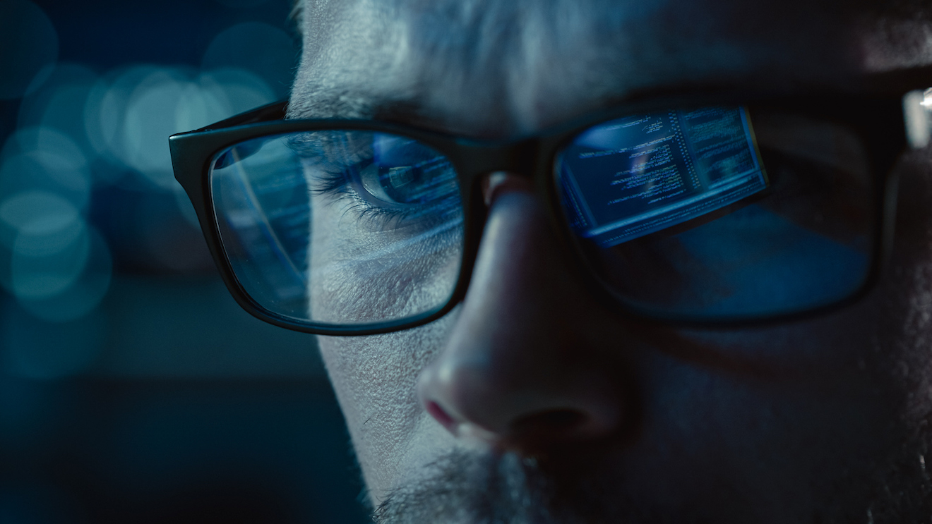 Close-up Portrait of Software Engineer Working on Computer, Line of Code Reflecting in Glasses. Developer Working on Innovative e-Commerce Application using Machine Learning, AI Algorithm, Big Data real time feedback